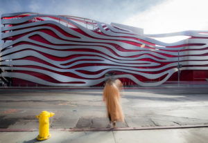 Petersen Automotive Museum of Los Angeles, facade, modern architecture, blurred person in the foreground Petersen Automotive Museum of Los Angeles, facade, modern architecture, blurred person in the foreground